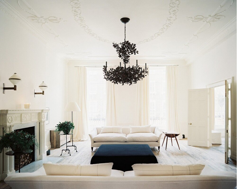 A white chandelier on a white ceiling