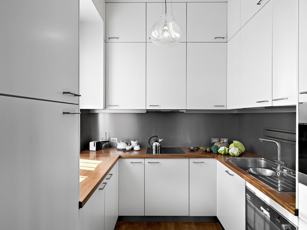 White and gray kitchen with a wooden countertop