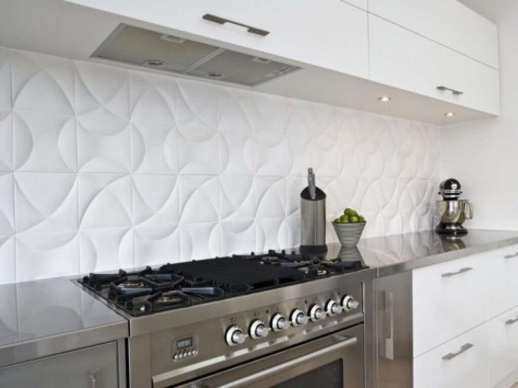 A kitchen backsplash made of large tiles