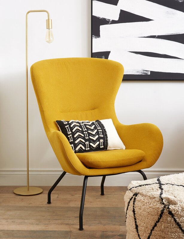 A mustard-colored armchair in the interior