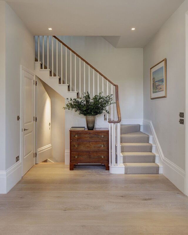 A corridor in the house with a staircase