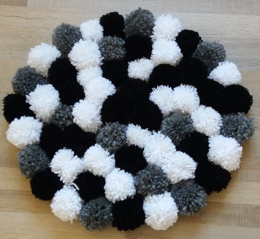 A rug made of pom-poms