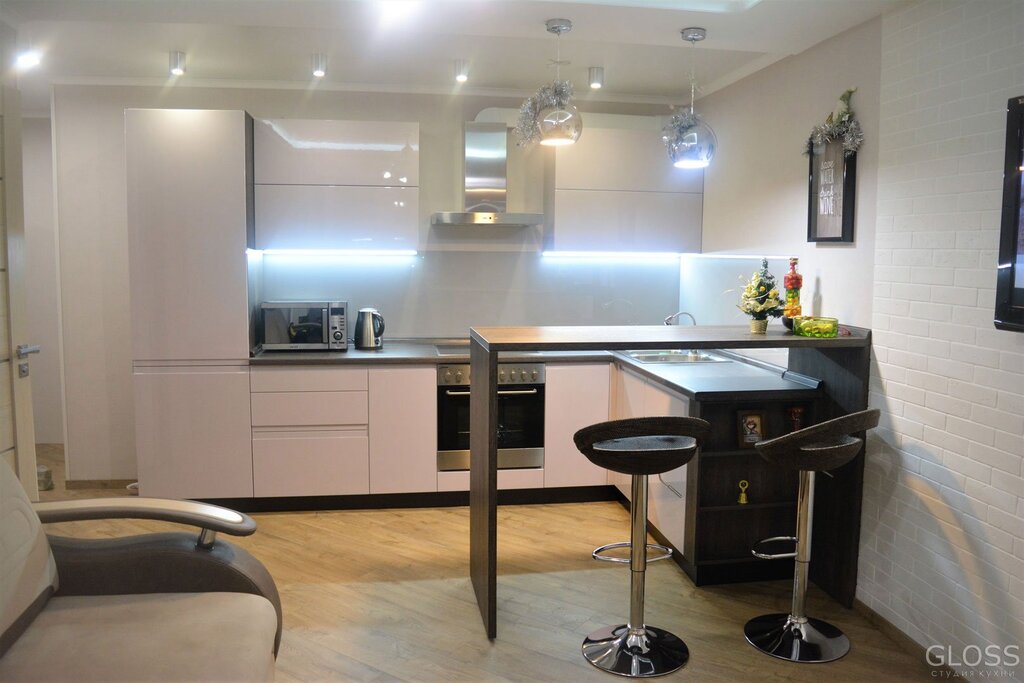 A kitchen with a bar counter and a sofa