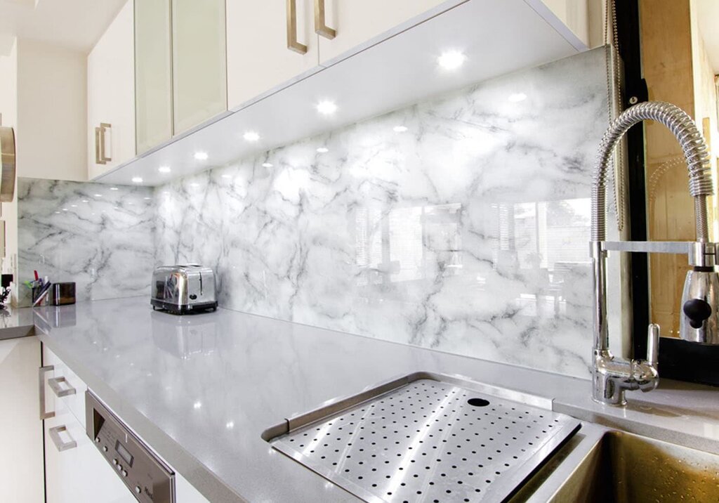 A kitchen with a marble backsplash