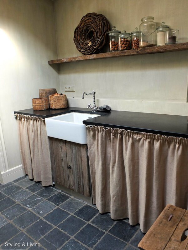 A kitchen with curtains instead of cabinets