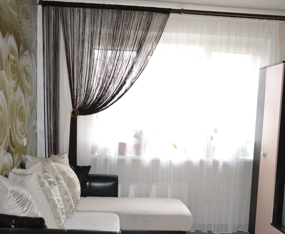 Thread curtains with tulle in the interior