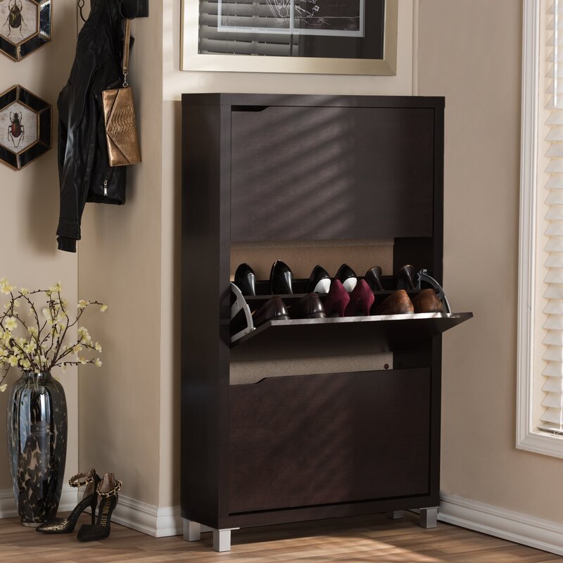 A hallway cabinet with a shoe rack