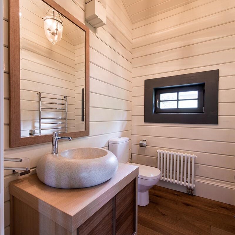 A bathroom paneled with clapboard