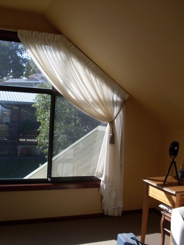 Sheer curtain for an attic window