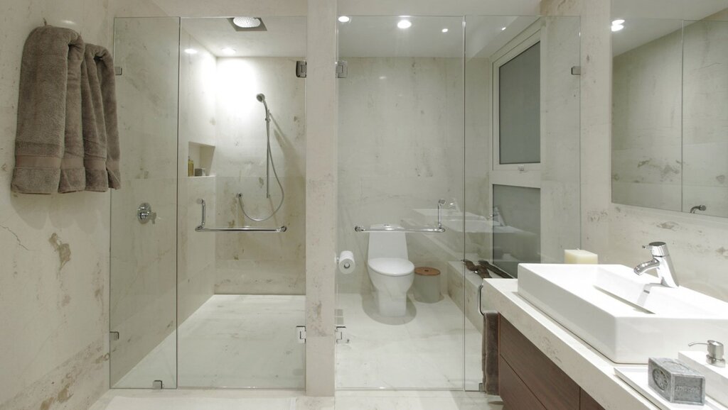 A bathroom with a shower partition