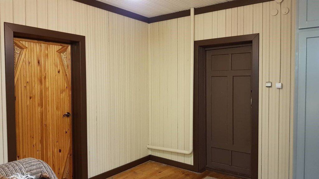 Entrance door paneled with clapboard