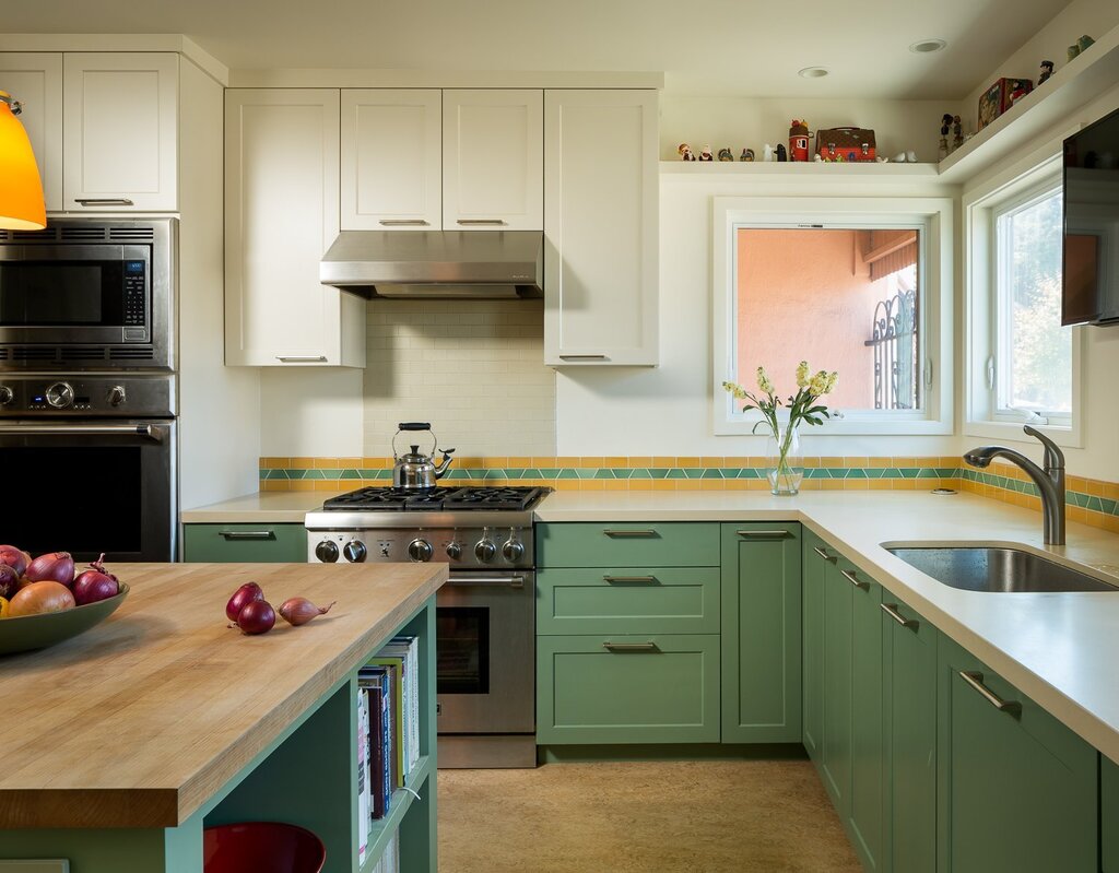 Green kitchen with a wooden countertop